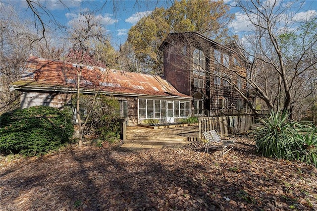 exterior space with a sunroom and a wooden deck