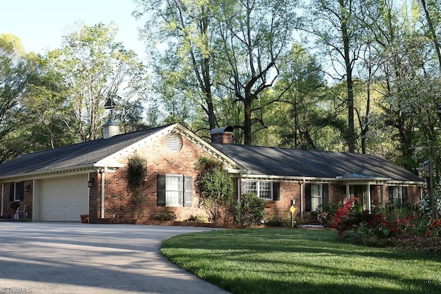 ranch-style home with a front yard and a garage