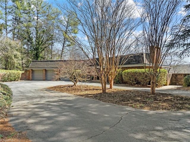 view of front of property featuring brick siding and driveway