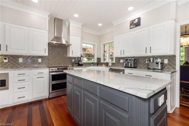 kitchen with dark wood finished floors, white cabinetry, wall chimney exhaust hood, stainless steel appliances, and gray cabinets