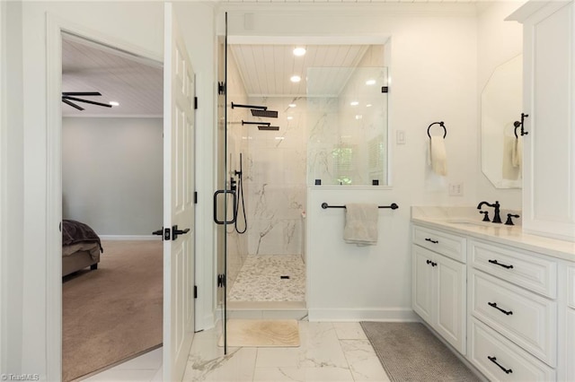 ensuite bathroom with recessed lighting, baseboards, marble finish floor, vanity, and a marble finish shower