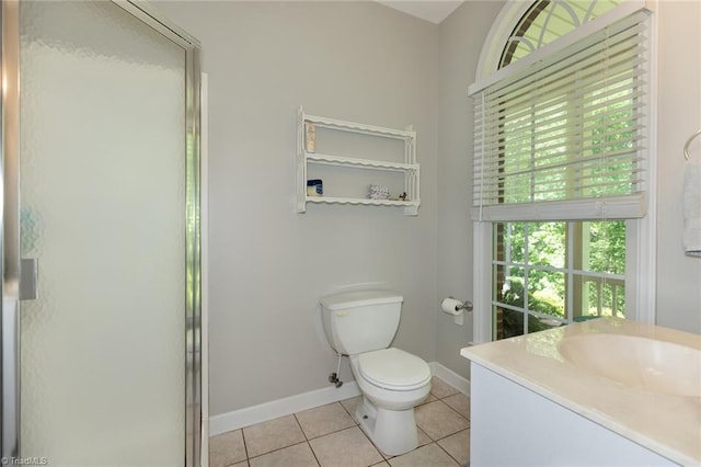 full bath featuring a shower with door, toilet, baseboards, tile patterned floors, and vanity