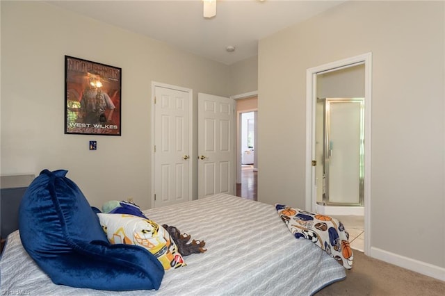 bedroom featuring connected bathroom, carpet, and baseboards