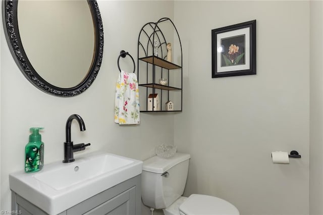 bathroom with toilet and vanity
