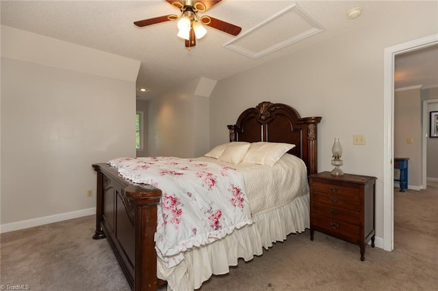 bedroom with baseboards, ceiling fan, attic access, and carpet
