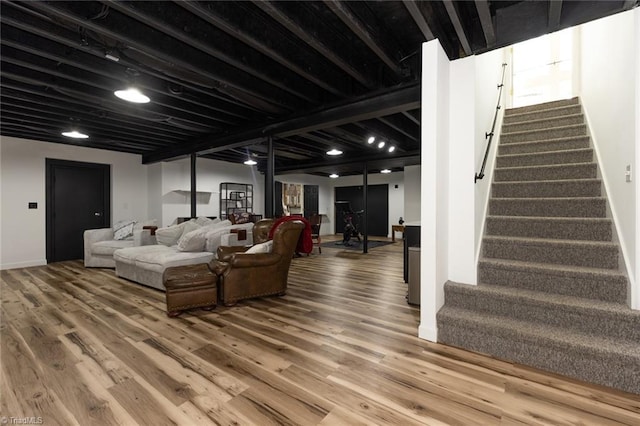 living room featuring stairway and wood finished floors
