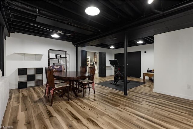 dining area featuring light wood finished floors and baseboards