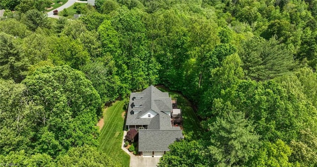 drone / aerial view featuring a wooded view