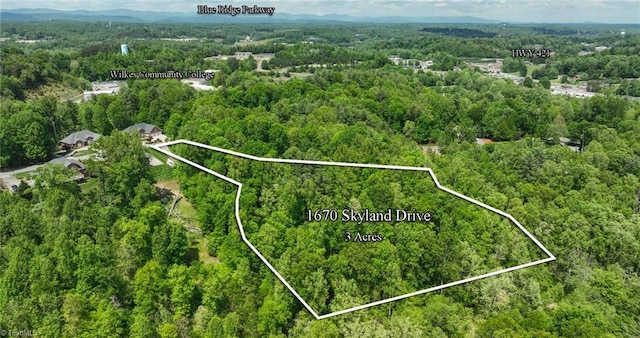 aerial view featuring a view of trees