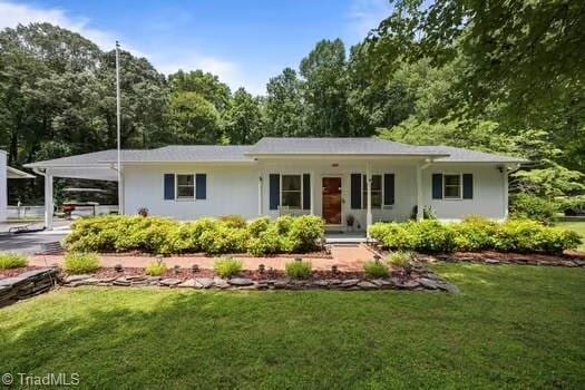 1630 Ploughboy Ln, Winston-Salem, NC 27103 - single story home with a front yard and an attached carport