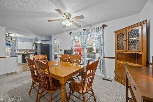 1630 Ploughboy Ln, Winston-Salem, NC 27103 - dining room with healthy amount of natural light, light colored carpet, and ceiling fan