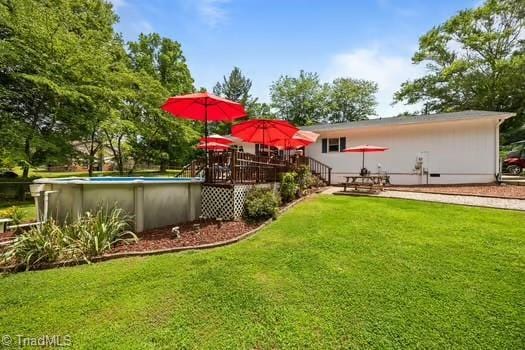 1630 Ploughboy Ln, Winston-Salem, NC 27103 - view of green lawn with an outdoor pool and a deck
