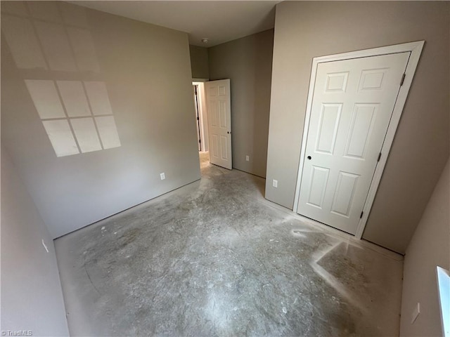 311 W Market St, Graham, NC 27253 - unfurnished bedroom with concrete flooring