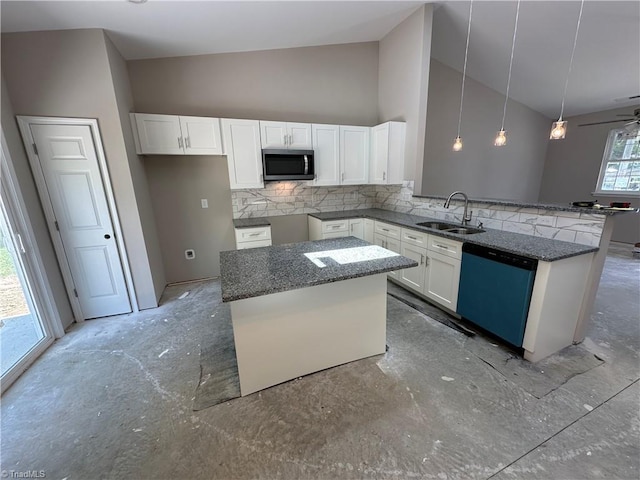 311 W Market St, Graham, NC 27253 - kitchen with dishwashing machine, a sink, stainless steel microwave, backsplash, and white cabinetry