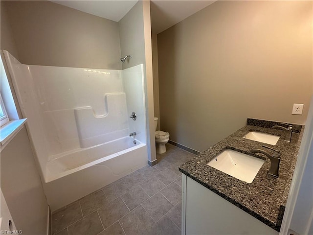 311 W Market St, Graham, NC 27253 - bathroom featuring toilet, double vanity, and shower / washtub combination