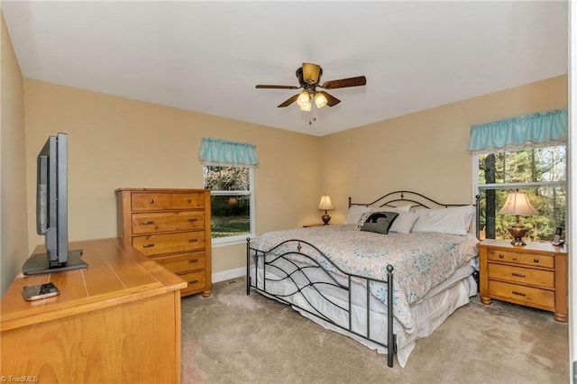 bedroom with ceiling fan and light colored carpet