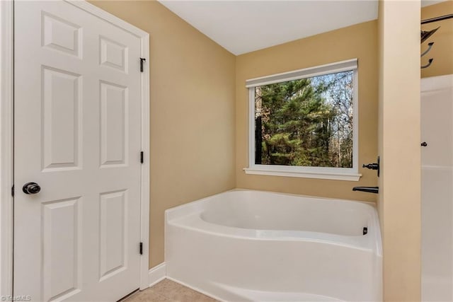 bathroom featuring tile patterned flooring and a bath