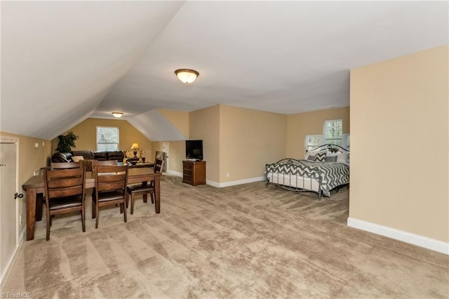 carpeted bedroom featuring lofted ceiling