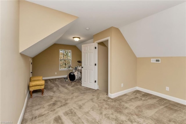 bonus room with carpet flooring and lofted ceiling