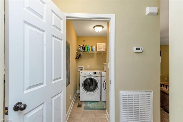 washroom featuring washing machine and clothes dryer and light tile patterned flooring