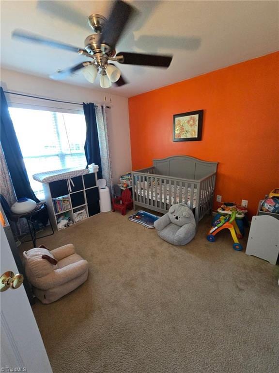 6108 Trotting Pl, Greensboro, NC 27405 - bedroom with carpet floors, a crib, and a ceiling fan