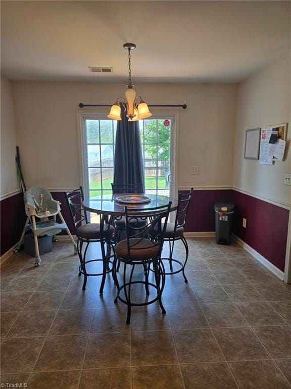6108 Trotting Pl, Greensboro, NC 27405 - dining room featuring a chandelier and dark tile patterned floors
