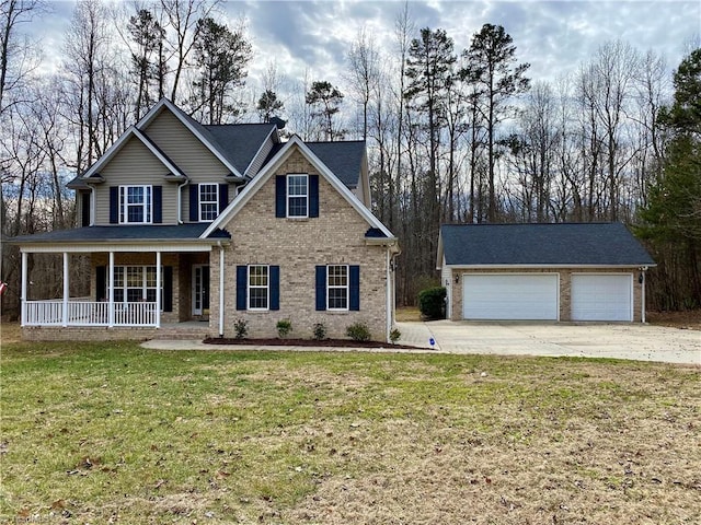 view of front of home featuring a garage, a front yard, and a porch