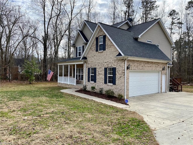 view of property with a garage, a porch, and a front yard