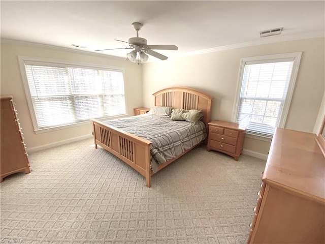 carpeted bedroom featuring crown molding and ceiling fan