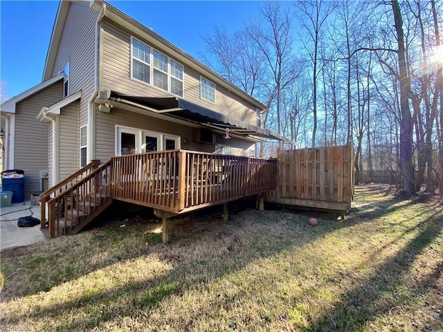 rear view of property with a yard and a deck