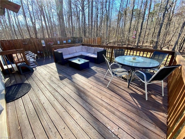 wooden deck with an outdoor living space with a fire pit