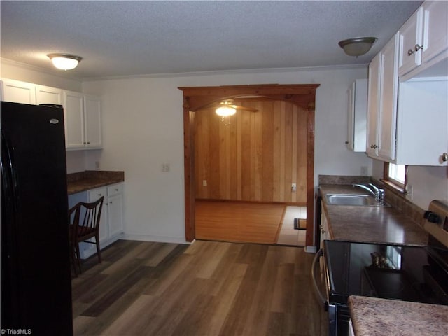 kitchen with white cabinets, sink, dark hardwood / wood-style flooring, and black appliances