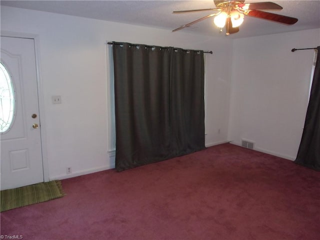 carpeted foyer entrance featuring ceiling fan