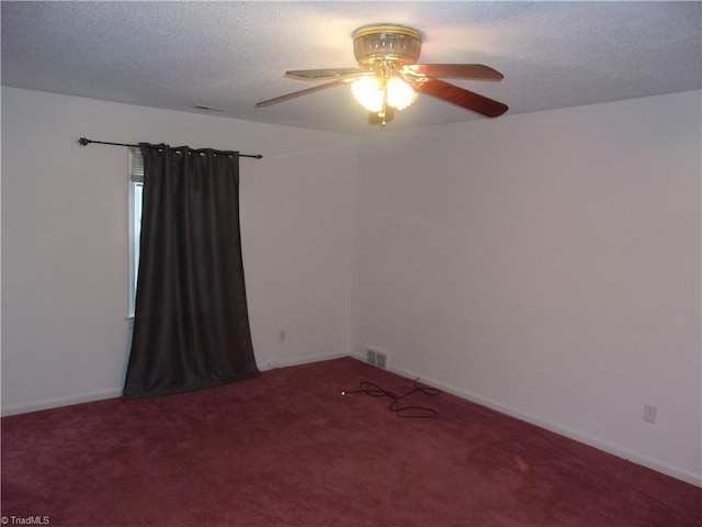 unfurnished room with ceiling fan, a textured ceiling, and carpet