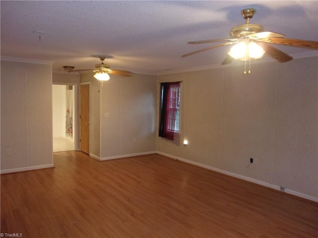 spare room featuring ceiling fan, hardwood / wood-style flooring, and ornamental molding