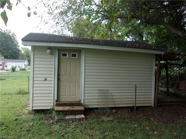 view of outbuilding featuring a yard