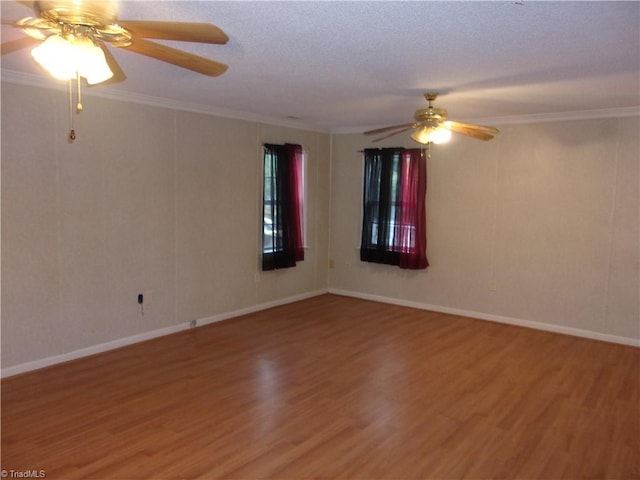 spare room featuring ceiling fan, a textured ceiling, crown molding, and wood-type flooring