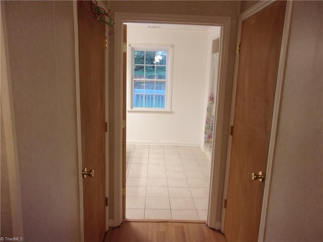 hallway with light tile patterned floors