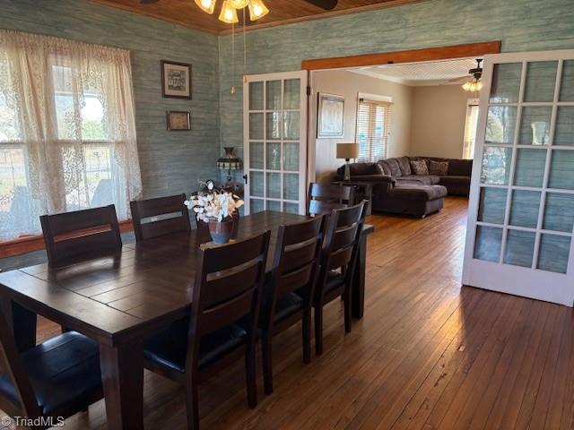 dining space featuring french doors, hardwood / wood-style floors, a ceiling fan, and crown molding