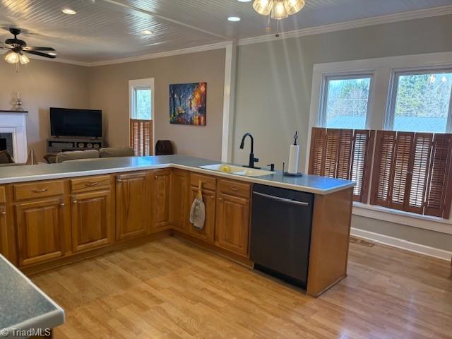 kitchen featuring a sink, a ceiling fan, brown cabinetry, and dishwasher