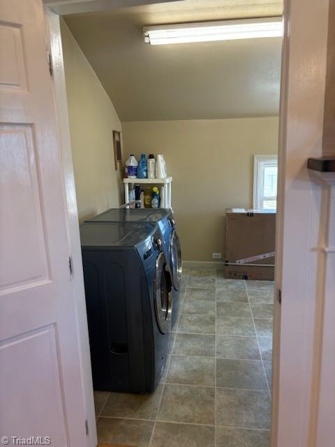 laundry room with tile patterned floors, laundry area, and separate washer and dryer