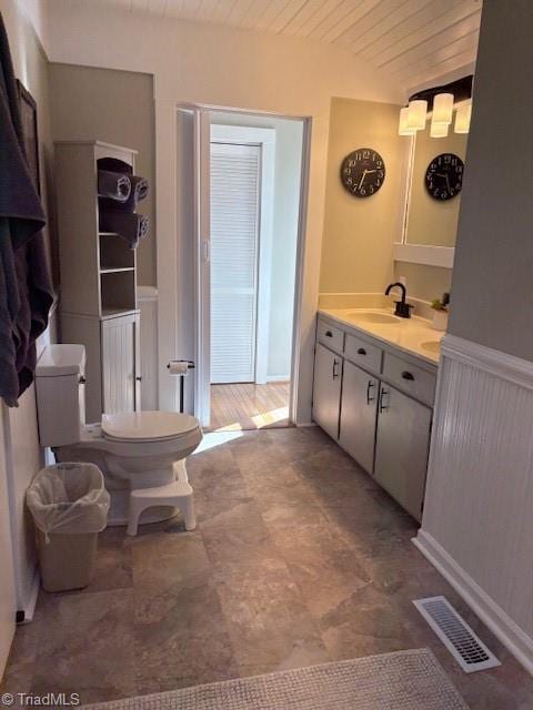 bathroom featuring lofted ceiling, visible vents, toilet, wood ceiling, and vanity