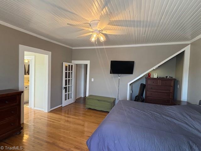 bedroom with ornamental molding, a ceiling fan, and wood finished floors