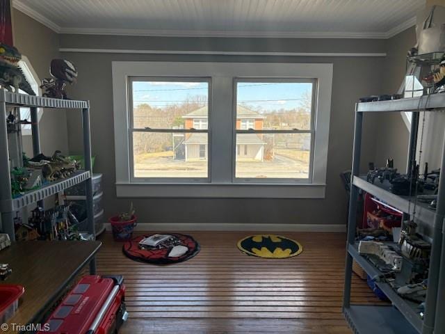 playroom with ornamental molding, baseboards, and hardwood / wood-style flooring