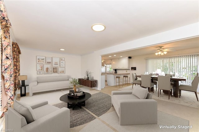 living room featuring light colored carpet, ceiling fan, and recessed lighting