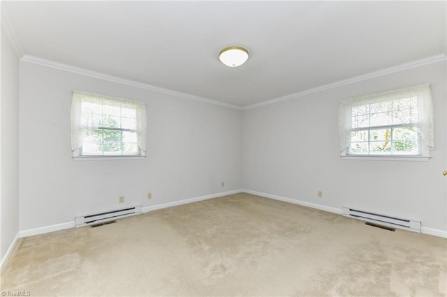 carpeted spare room with plenty of natural light, crown molding, and a baseboard heating unit