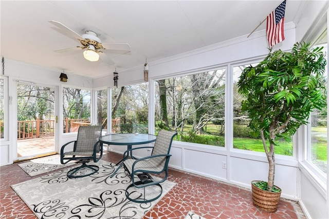 sunroom with a wealth of natural light and ceiling fan