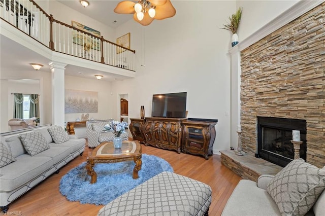 6065 Providence Church Rd, Winston-Salem, NC 27105 - living room featuring a fireplace, wood finished floors, a ceiling fan, and a high ceiling