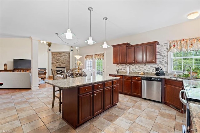 6065 Providence Church Rd, Winston-Salem, NC 27105 - kitchen featuring light stone countertops, a breakfast bar area, decorative light fixtures, appliances with stainless steel finishes, and a sink