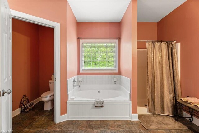6065 Providence Church Rd, Winston-Salem, NC 27105 - bathroom featuring a bath, toilet, a stall shower, stone finish floor, and baseboards